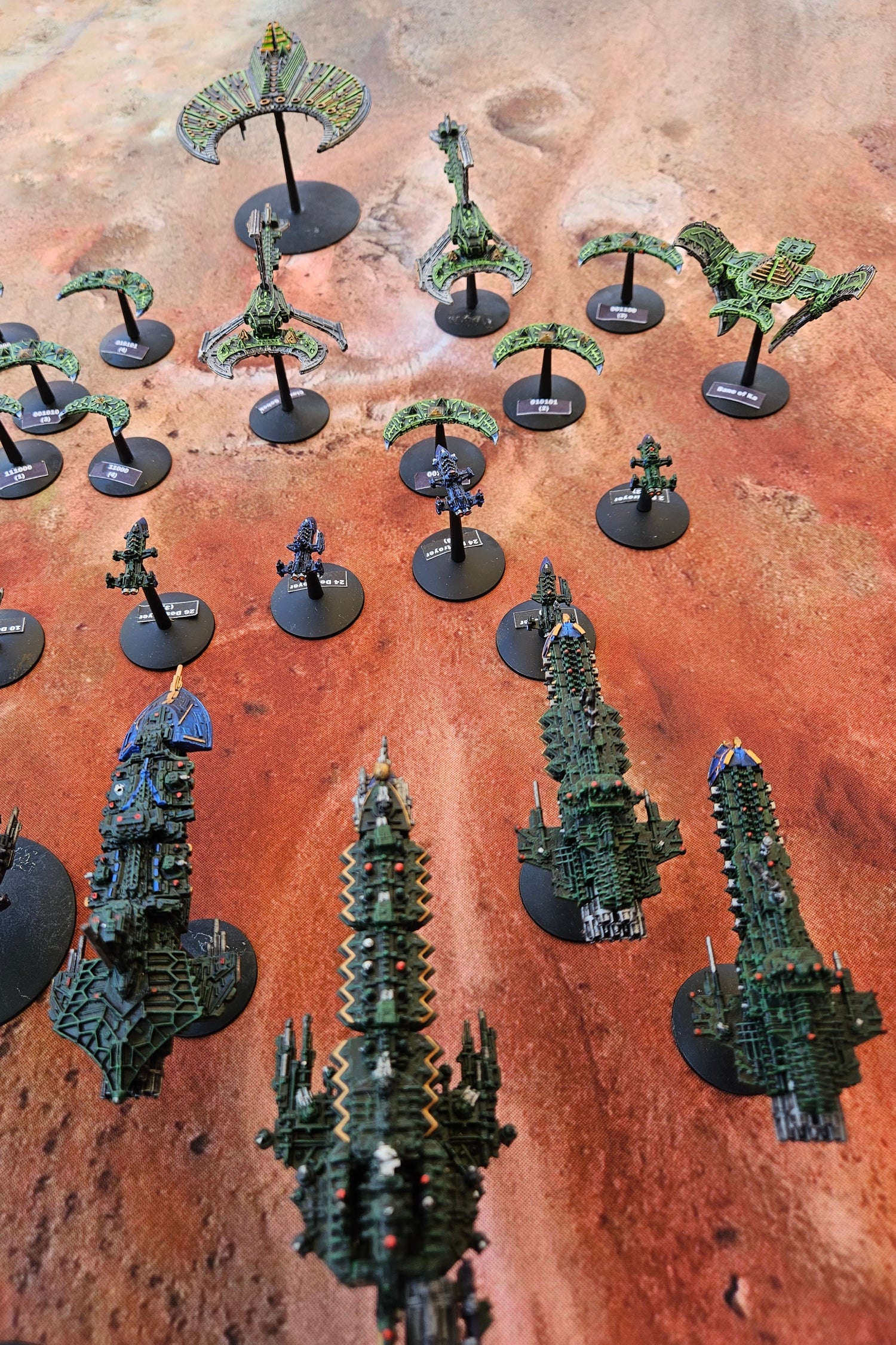 Miniature wargame figures on Red Planet Mars themed battle mat showing alien rocky terrain for Warhammer 40K and sci-fi tabletop gameplay