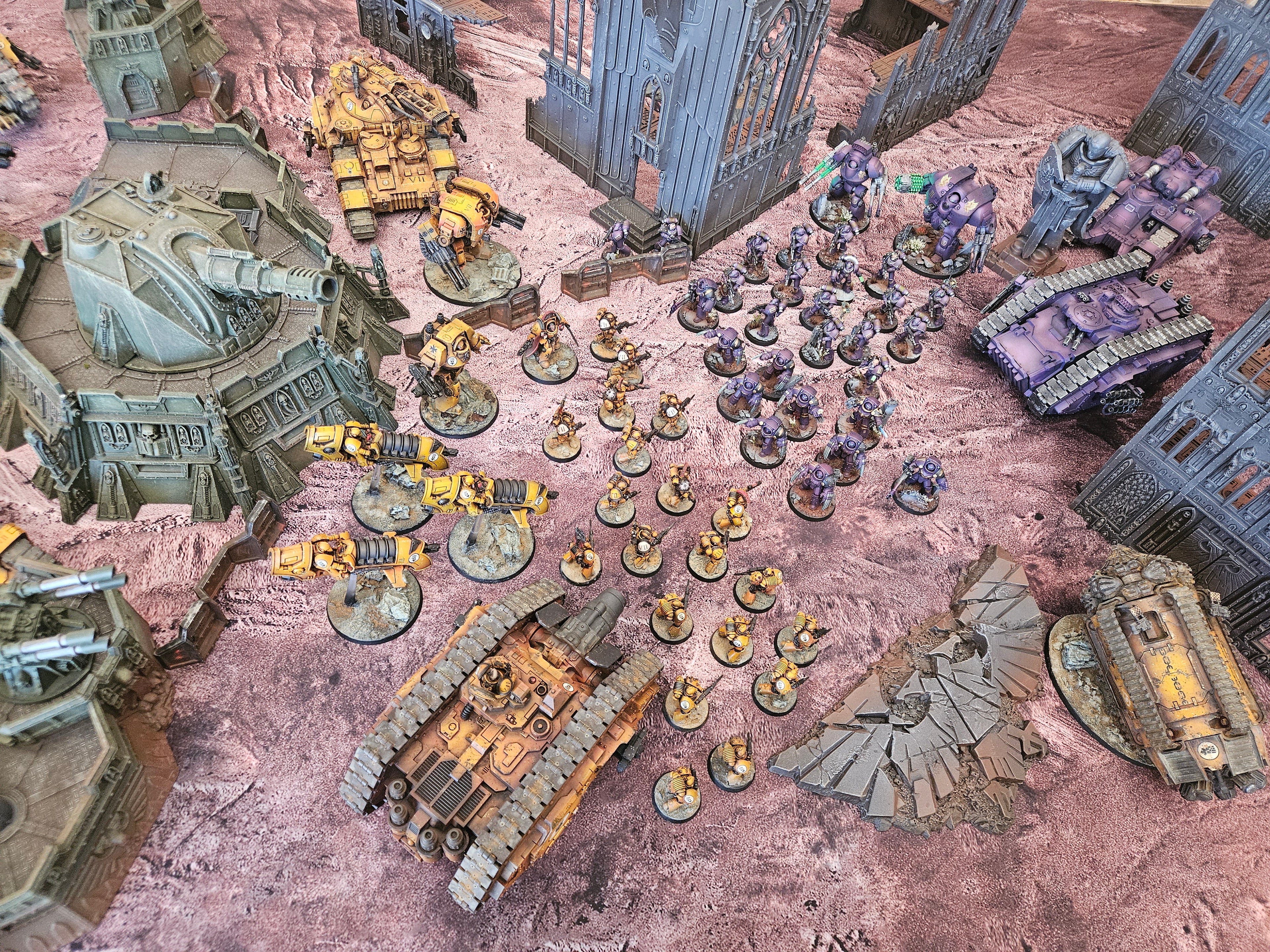 Scorched Earth wargaming battle mat with miniatures set in a ruined post-apocalyptic battlefield for Warhammer 40K gameplay
